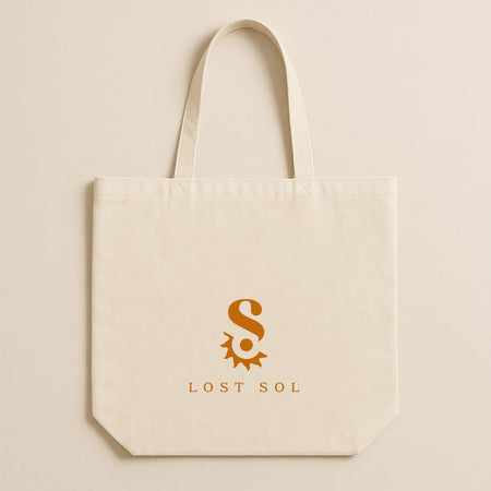 Lost Sol cream cotton canvas tote bag with the orange sun logo, 40 x 43cm